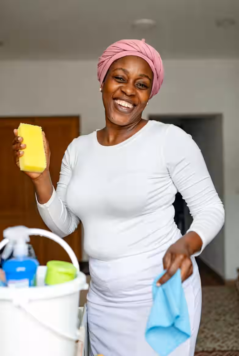 Professional housekeeper smiling, ready to work